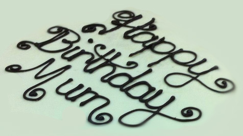 Example of writing on top of a cake drawn with melted chocolate