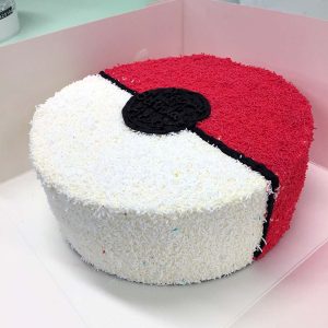 A birthday cake decorated to look like a Pokéball from Pokémon